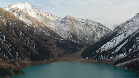 cinematic drone shot of the big almaty lake in the trans-ili alatau mountains in kazakhstan