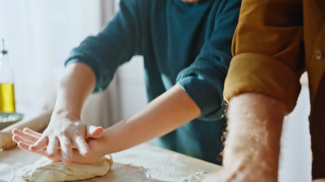 Family hands preparing dough enjoying relaxed domestic cooking together closeup