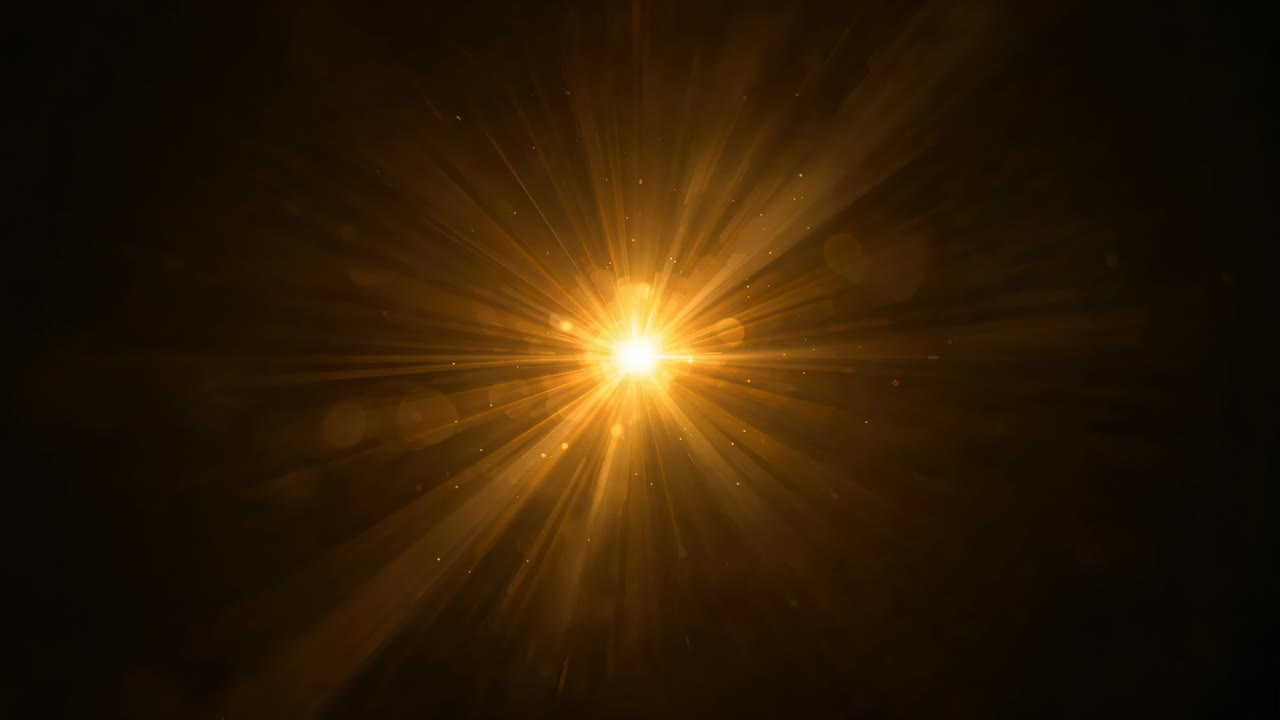 Brightening central light sending golden rays on dark field with bokeh discs, particles, starlike