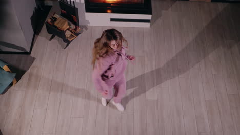 woman dancing in living room by fireplace