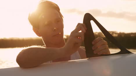 male rower preparing boat before practice