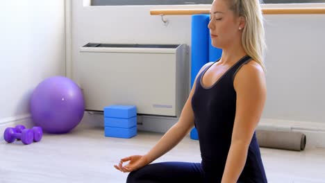 Woman-doing-yoga-in-fitness-gym-4k