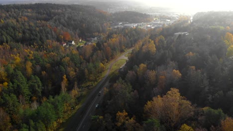 Toma-Aérea-Hacia-Atrás-De-La-Carretera-En-Un-Valle-Durante-La-Temporada-De-Otoño