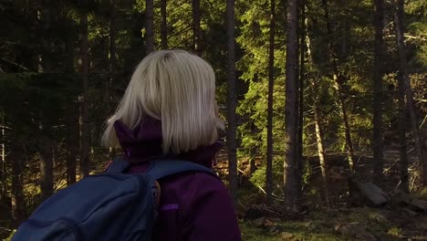 Attractive-young-blonde-woman-enjoys-exploring-the-outdoors-in-Apuseni-Natural-Park,-Romania,-Nature-reserve