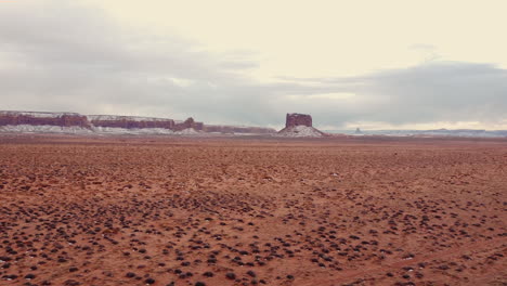 a drone shot of a beautiful arizona desert scene over the red desert soil and rock cliffs