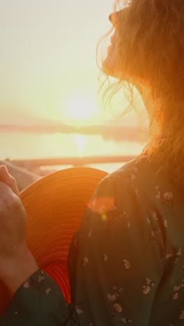 woman watching the sunset with curly hair