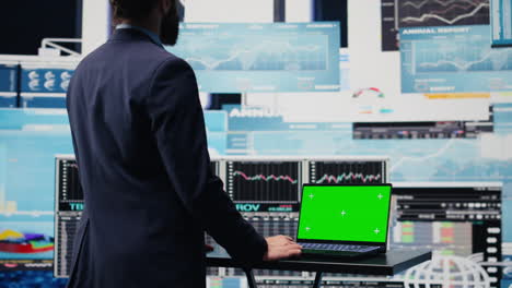 general director with a chroma key display reviewing performance metrics