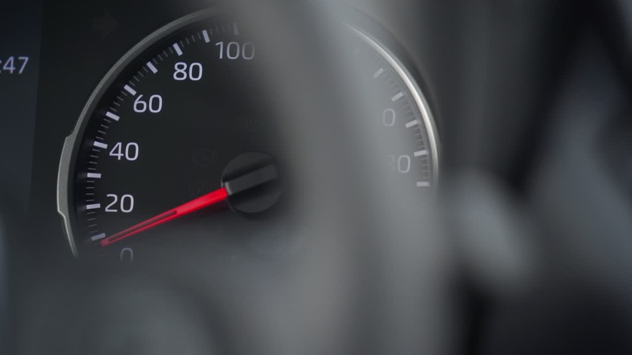 Car tachometer and moving pointer, car dashboard panel detail closeup