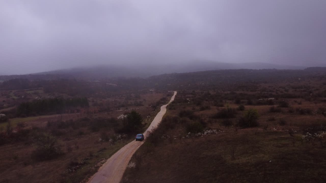 Car is driving slowly in the fog