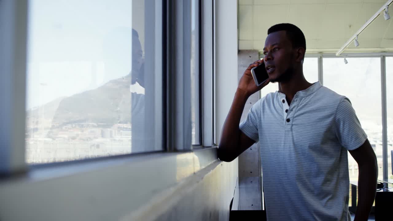 Executive talking on mobile phone in office