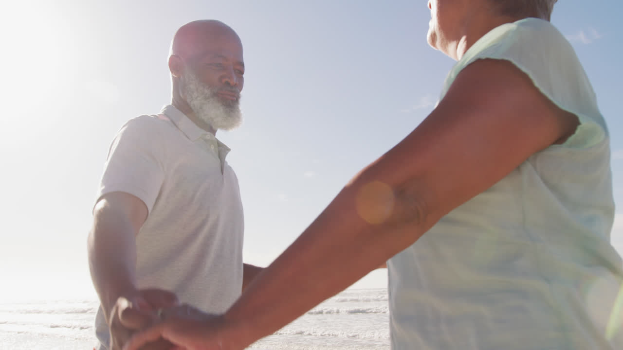 Senior african american couple dancing at the beach