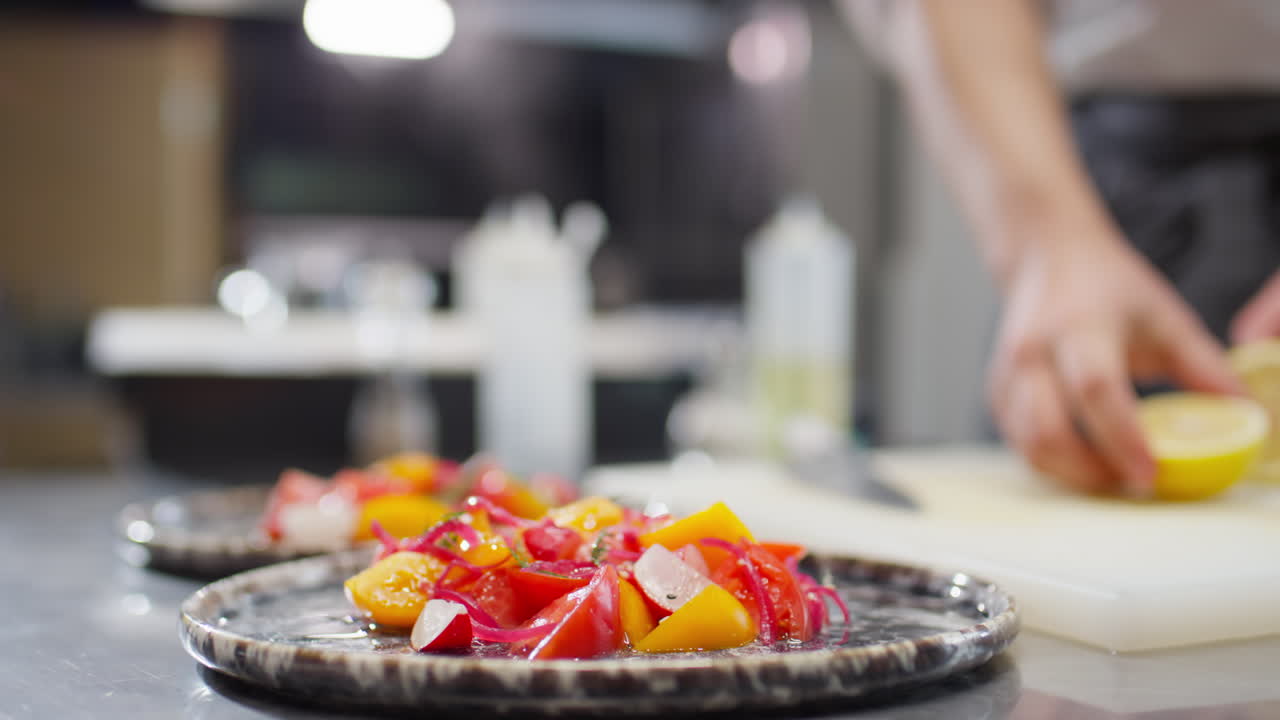 Adding Lemon Juice to Salad in Restaurant Kitchen