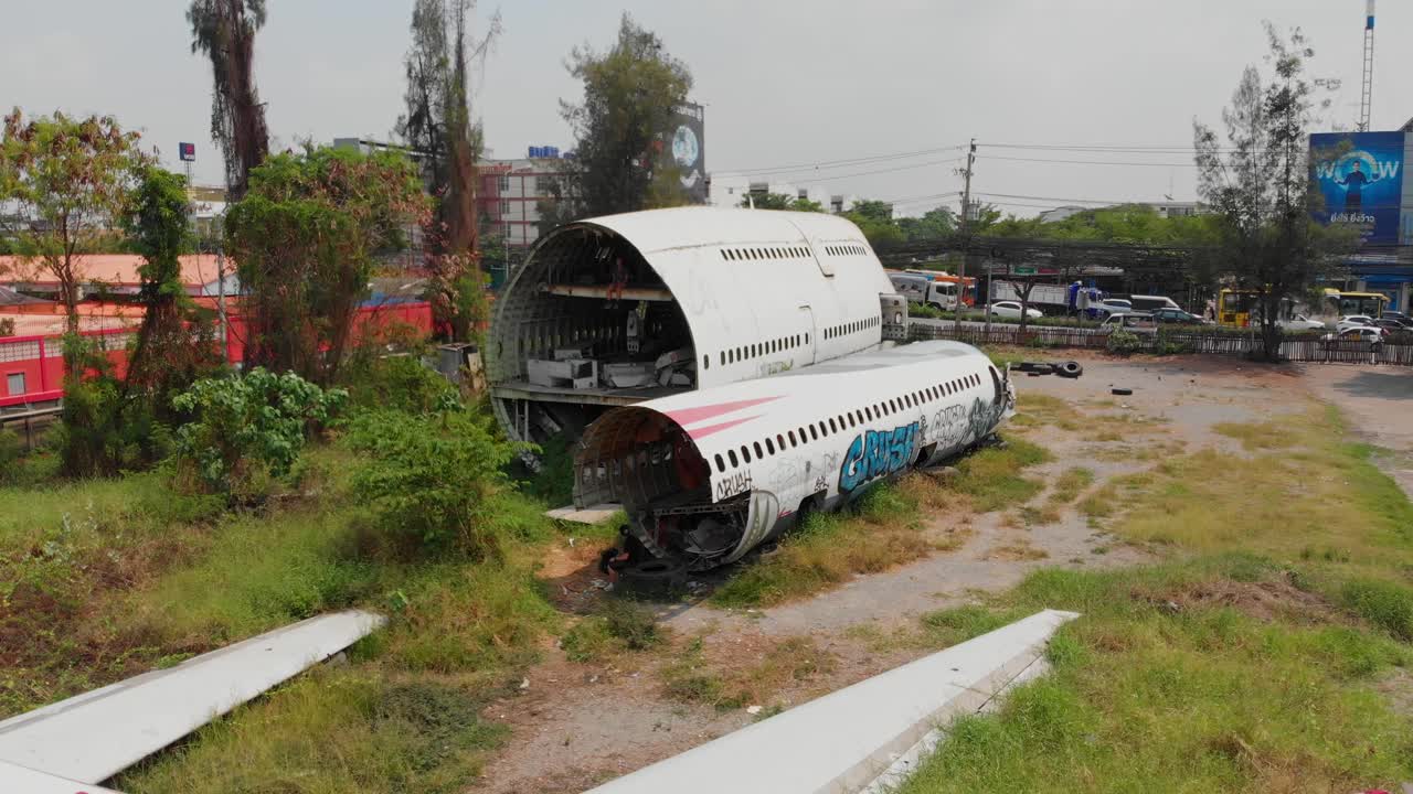 Aerial view of abandoned airplane graveyard with city skyline in background in Bangkok Thailand