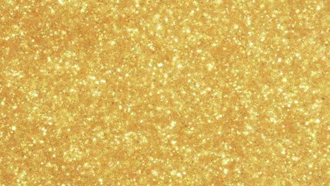 metallic gold particles flow through liquid and rain down. liquid art, microscopic macro backgrounds.