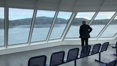 man watching scenery from ferry deck