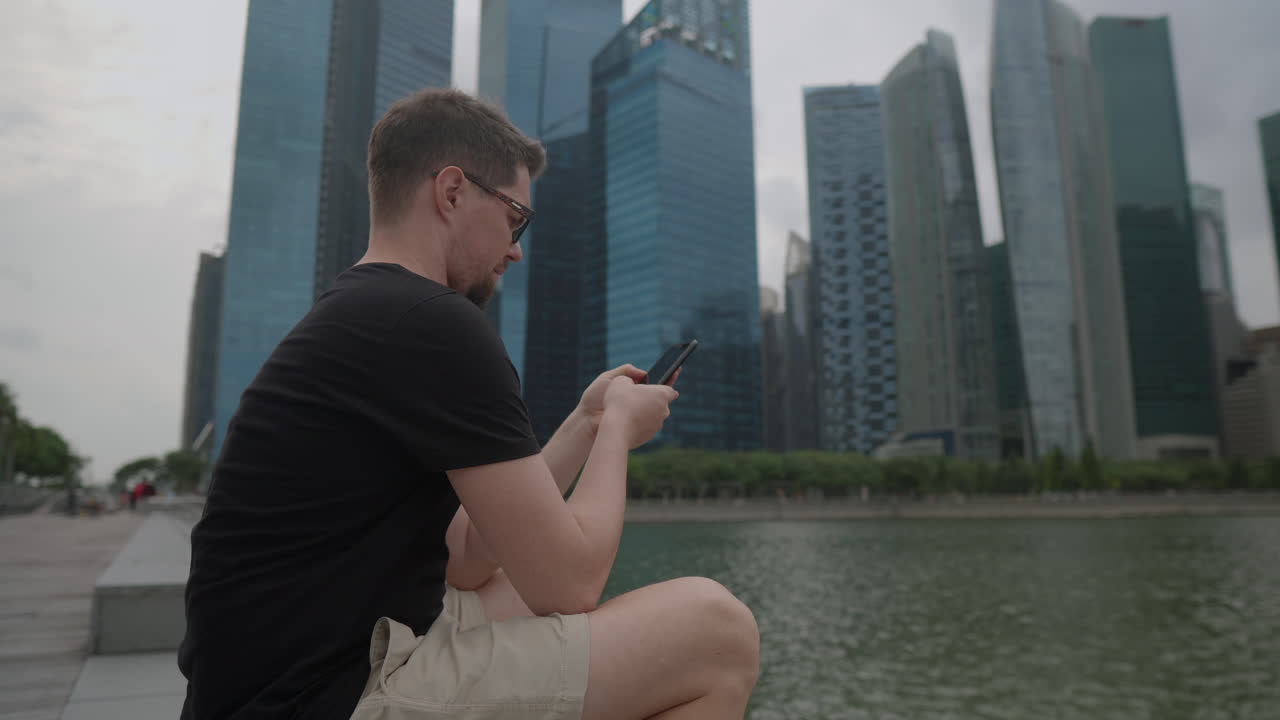 Man using smartphone in Singapore city