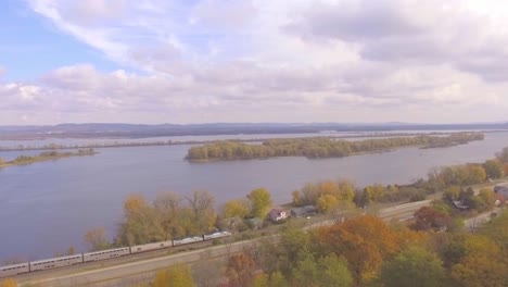 A-train-traveling-along-a-highway-in-autumn-in-Minnesota