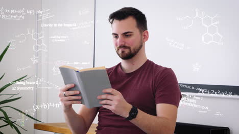 young male student reads science book and thinks about math formulas and equations