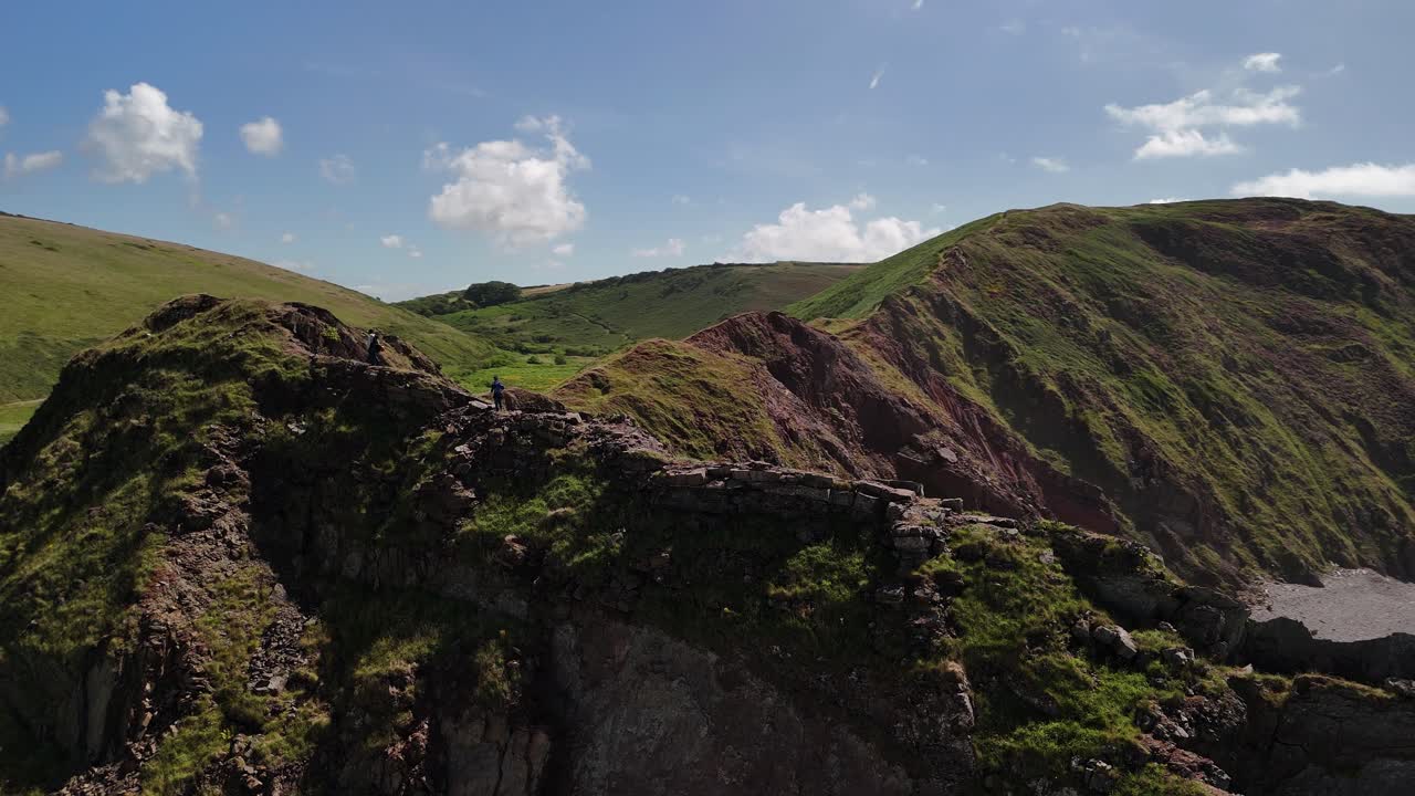 Aerial View of Hikers on Coastal Cliff Path