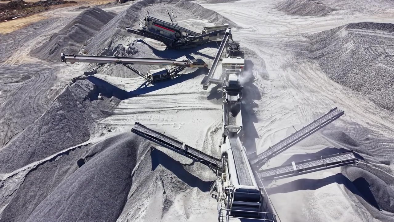 Granite quarry operation with machinery and materials in a mining site during daylight hours