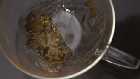 tea pouring into glass cup