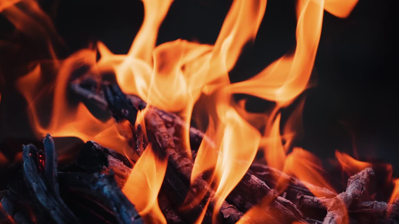 Fire burns in the fireplace. Evening mood. Holiday concept. Slow motion