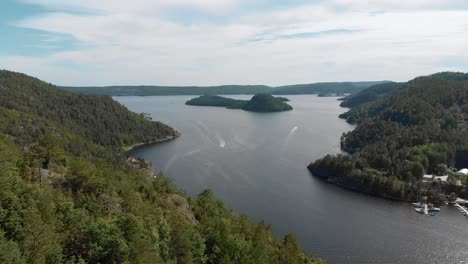 Beautiful-Norwegian-fjords-during-summer-with-boats-in-the-bay,-aerial-view