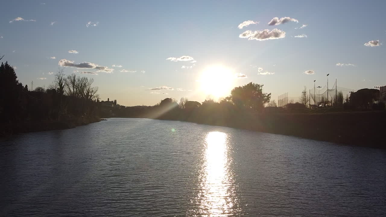 Flying in Sunset drone above the Arno river. Girone small town near Fiesole Florence, in the Tuscany region of Italy. December 2019
