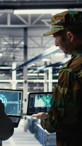 vertical video military commander and female programmer in data center tracking coordinates