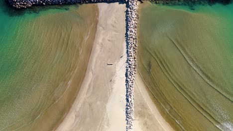 top-down shot of a ocean wave break protecting the shore from erosion