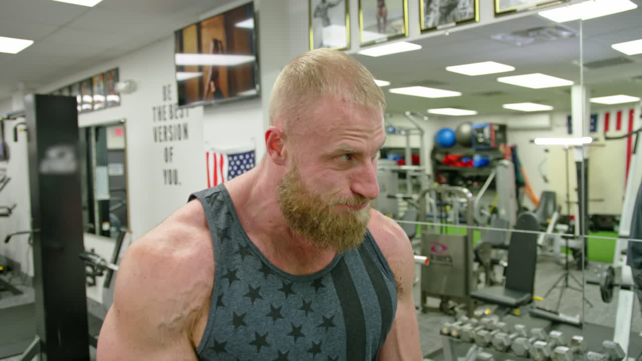 Strong bodybuilder strength workout in sport club