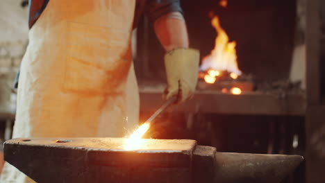 Blacksmith-Taking-off-Hot-Metal-from-Fire-and-Hammering-on-Anvil
