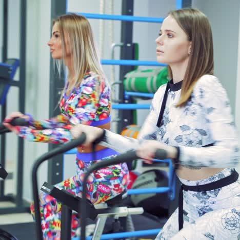 young women cycling in the gym