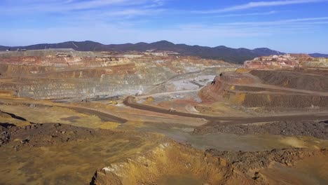 heavy machinery working in te riotinto open pit copper mine aerial shot