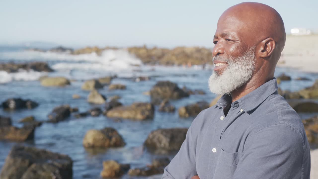 Happy senior african american man at beach, copy space, slow motion