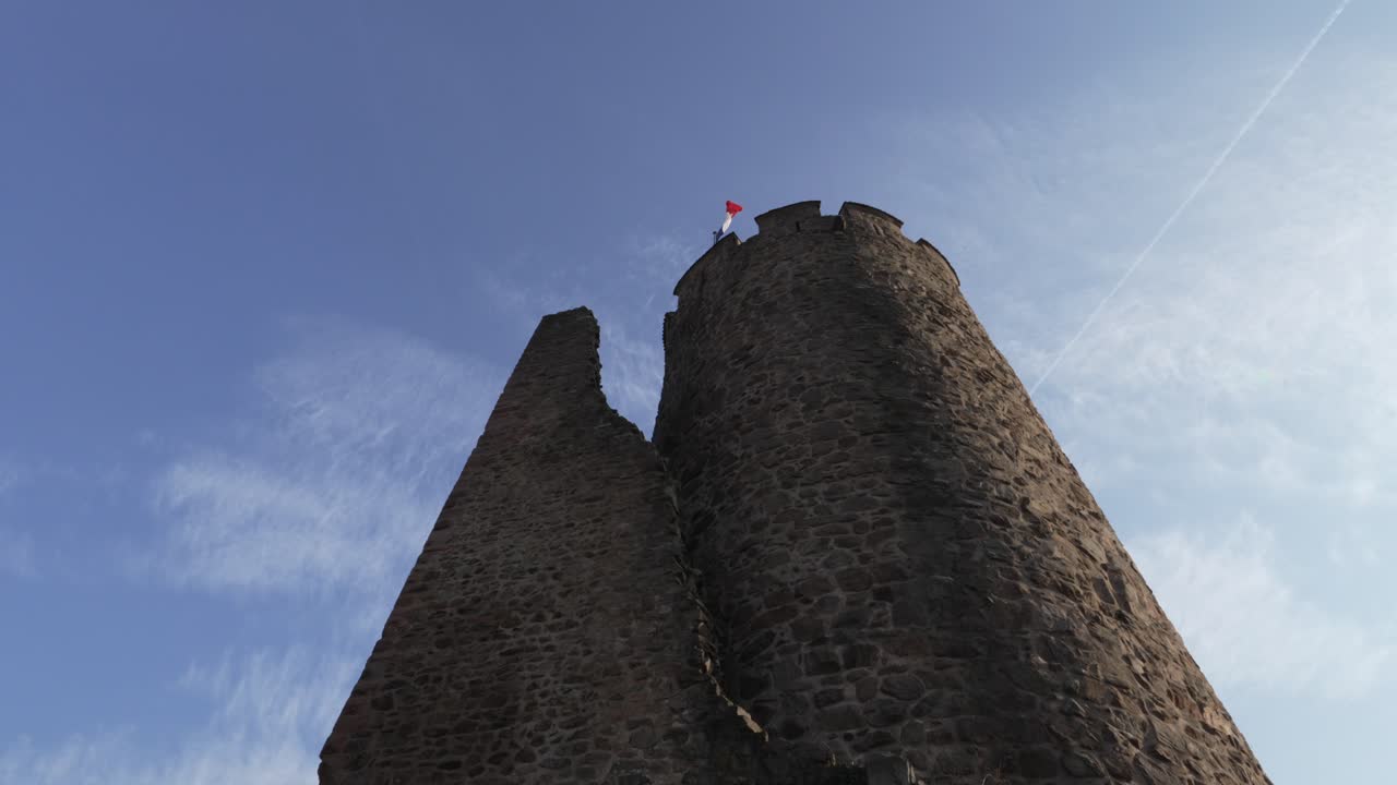 Medieval castle tower ru&iuml;n with the french flag on top in Kaysersberg, France