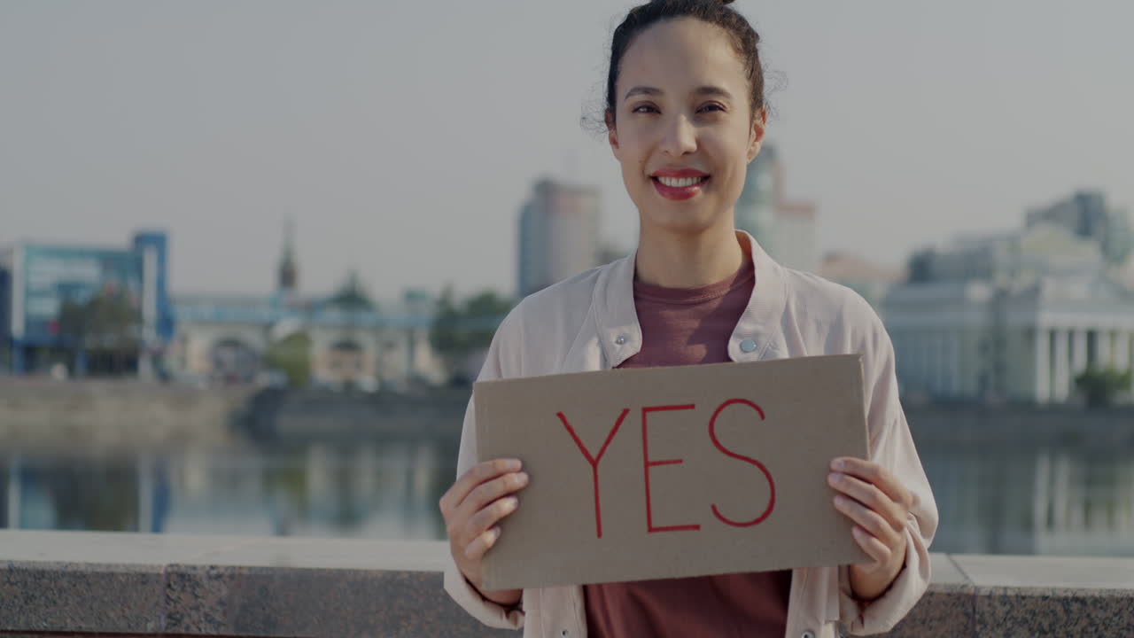 Woman Holding a Sign Saying 'Yes'