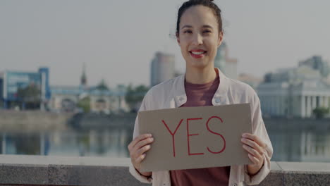 woman holding a sign saying 'yes'