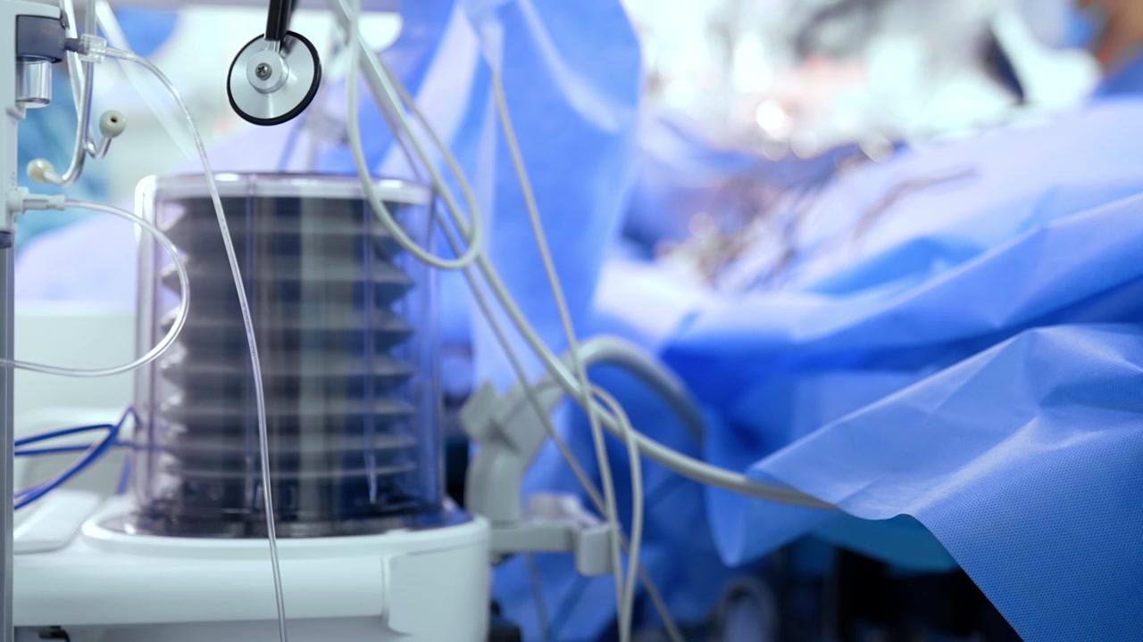 Apparecchiature mediche in funzione in sala operatoria durante un'operazione. La pompa del ventilatore polmonare si muove su e giù.