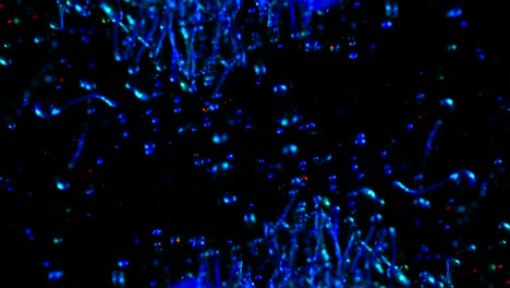 gotas de pintura de neón fluorescentes brillantes que chocan en cámara lenta