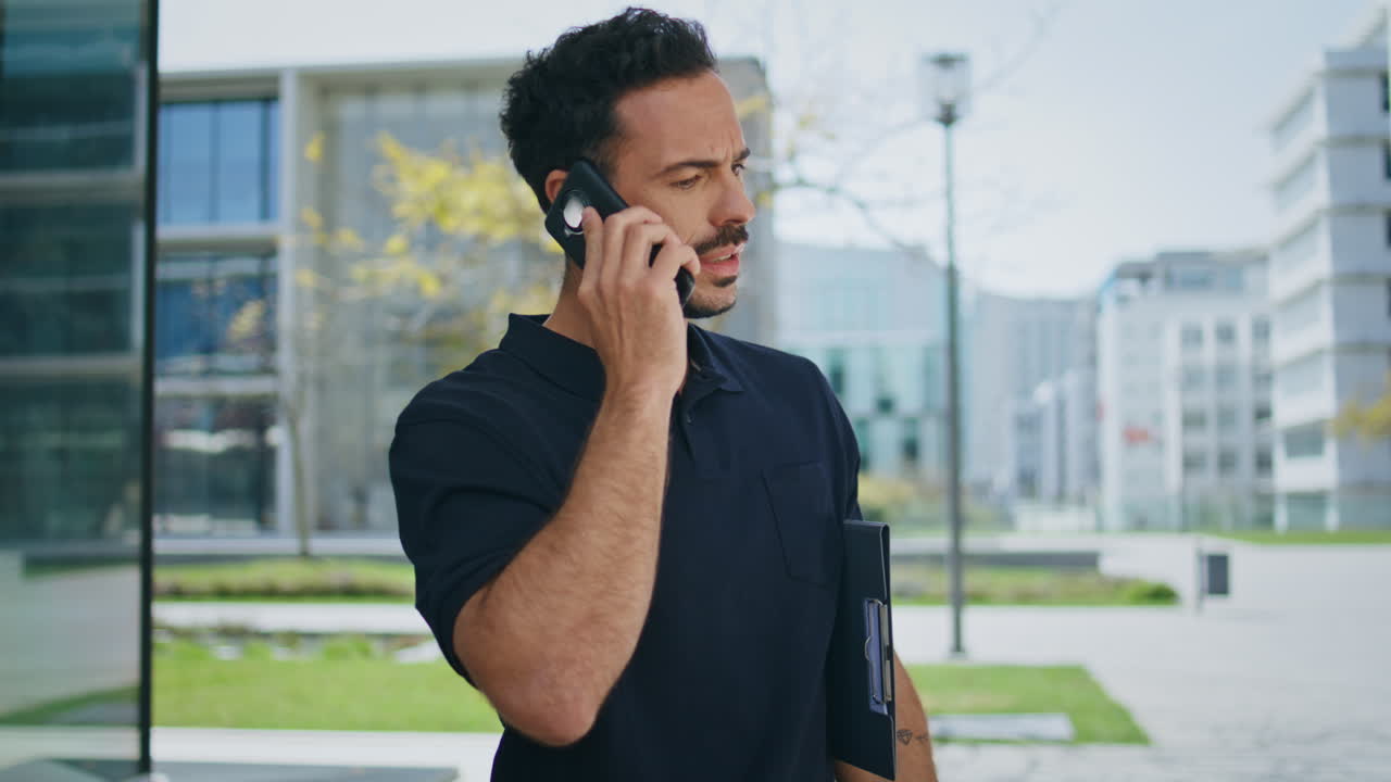 Busy businessman typing phone number calling at greenery street exterior closeup