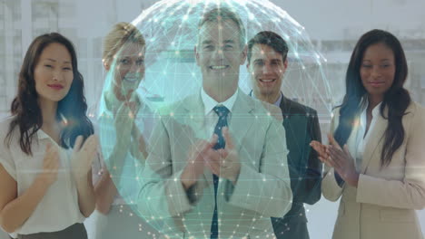 business team celebrating and clapping in open?plan office, with glowing holographic network sphere