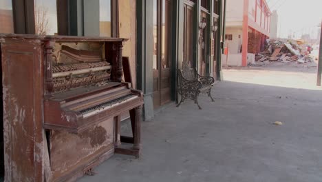an old piano sits in front of a glaveston bar after hurricane ike