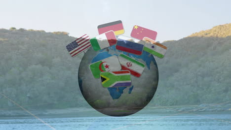 animation of flags rotating around globe above scenic landscape with mountains