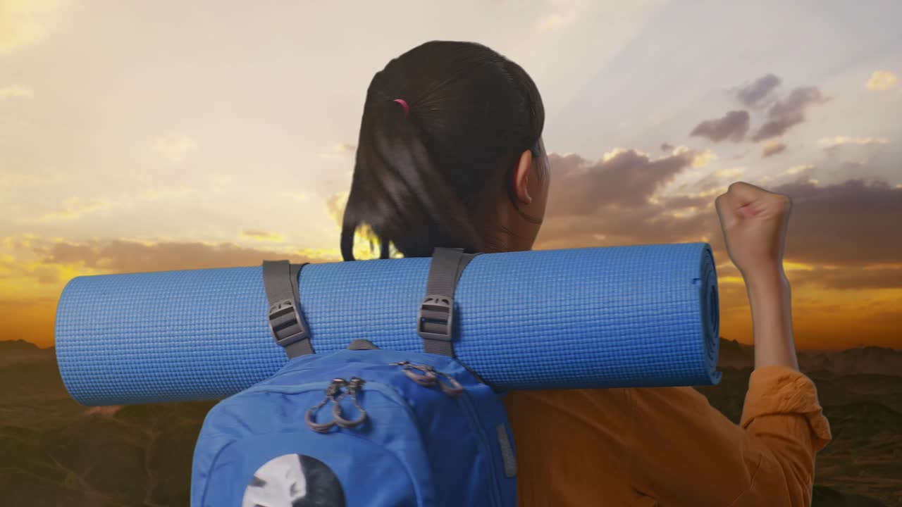 Woman Celebrating a Hiking Trip at Sunset