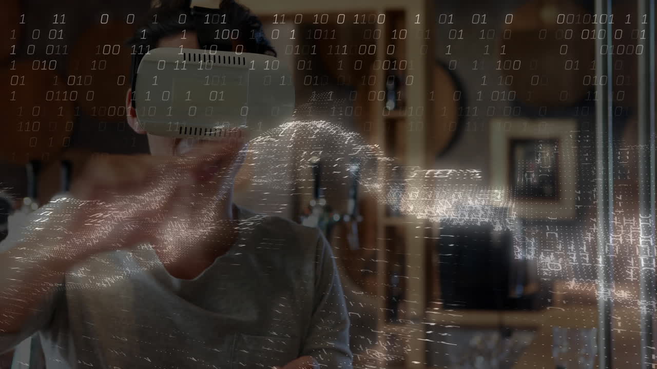 Man wearing VR headset manipulating holographic globe in technology lab, displaying binary code