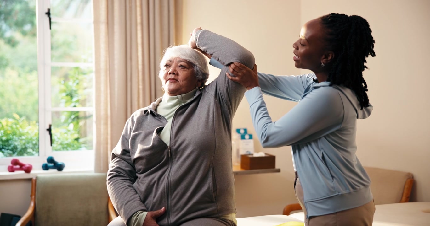 Physical Therapist Assisting Senior Woman with Shoulder Stretching Exercise
