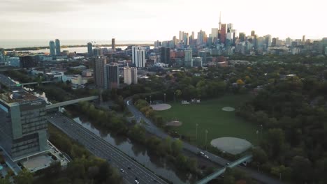 4k drone aerial shot of highway and toronto city as camera turns right