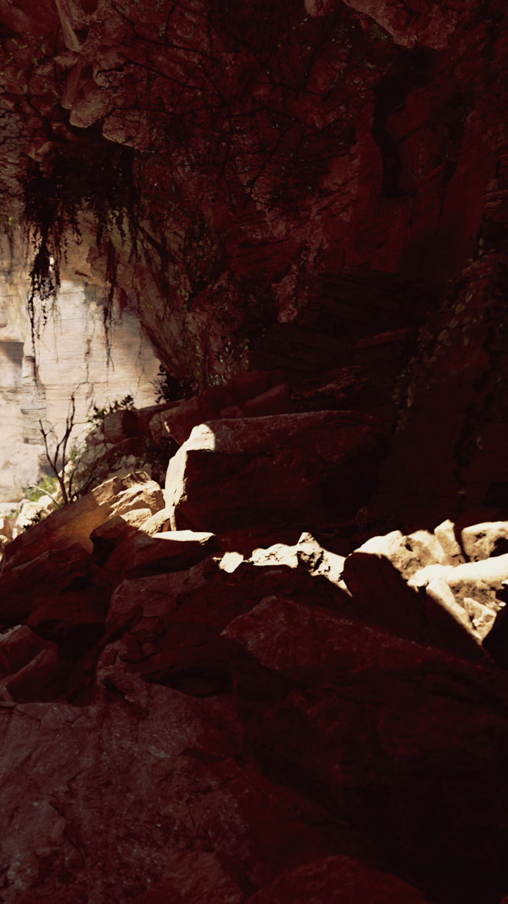 Exploring a stone pathway in a sunlit cave during the afternoon