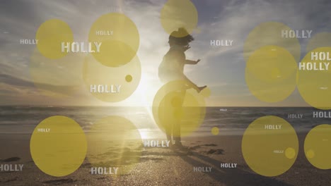 animation of holly texts over biracial mother and daughter at beach